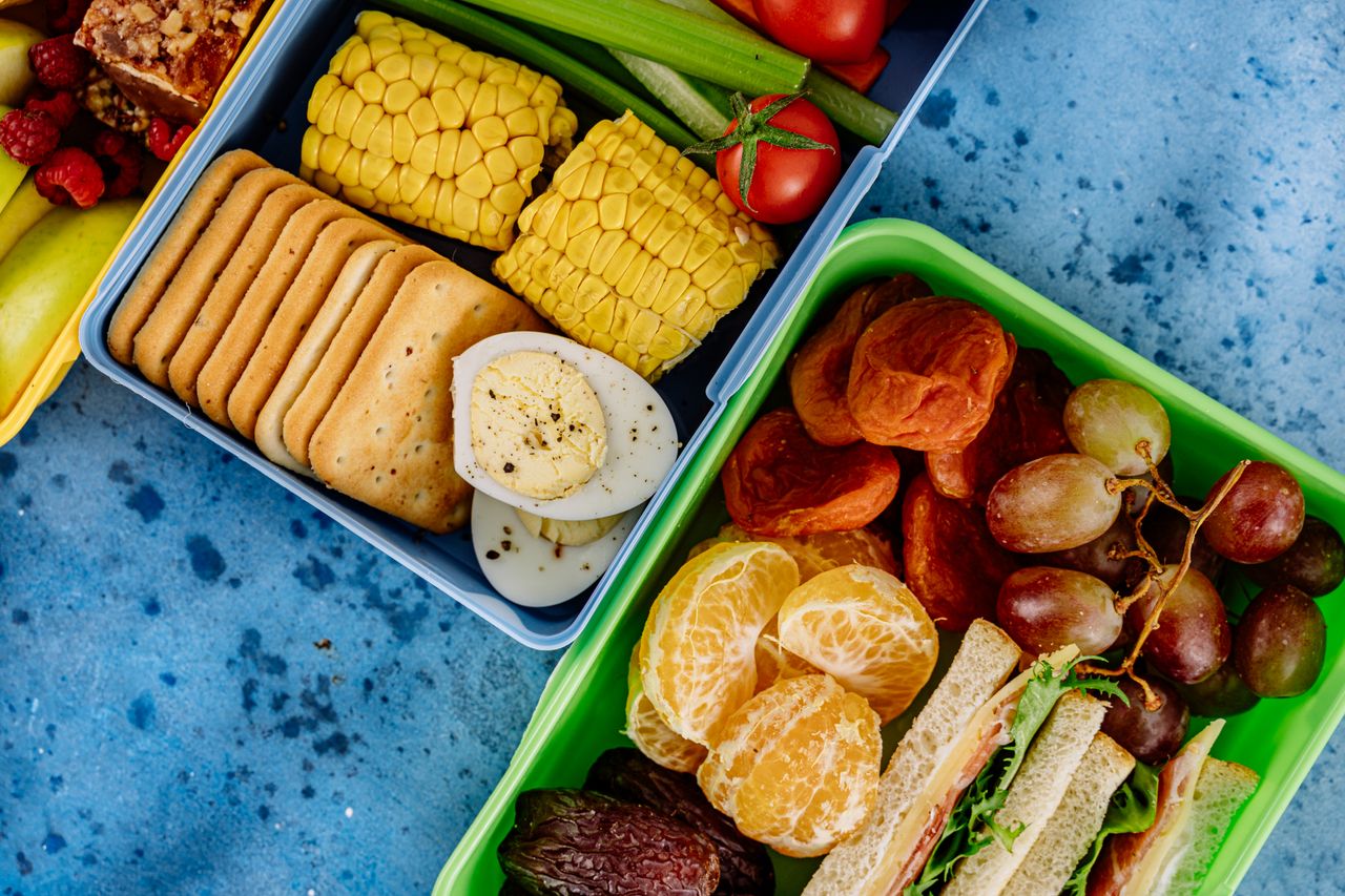 services-03 Colorful lunchboxes with fruits, snacks, and vegetables for a balanced meal.